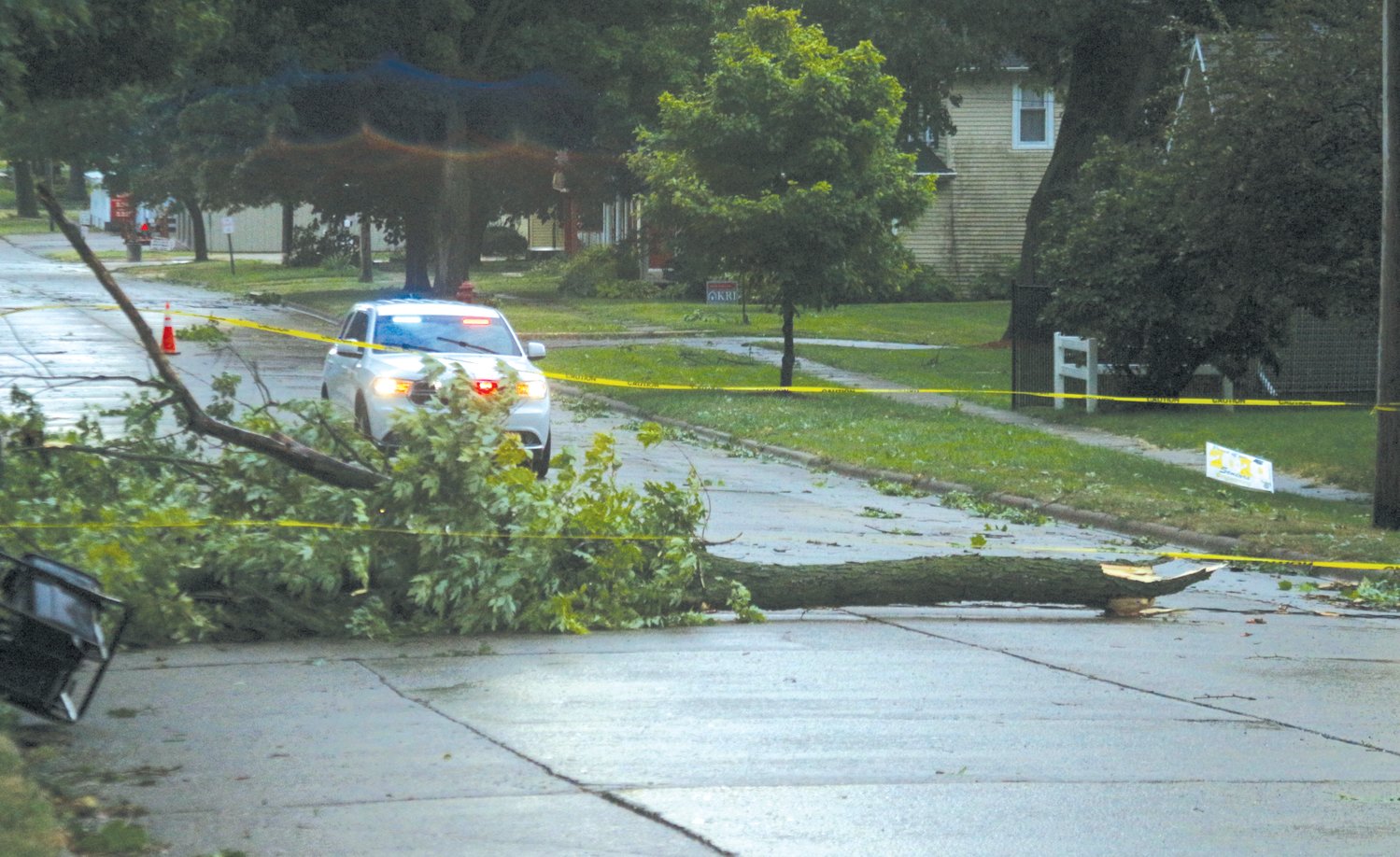 A tree blocks the way to Wellman’s business district on 9th Avenue following Monday’s storm outbreak.